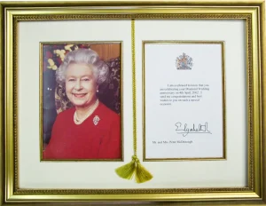 A bespoke picture framing from Nuneaton picture framers ltd designed to celebrate a royal anniversary or birthday congratulatory letter alongside the card.