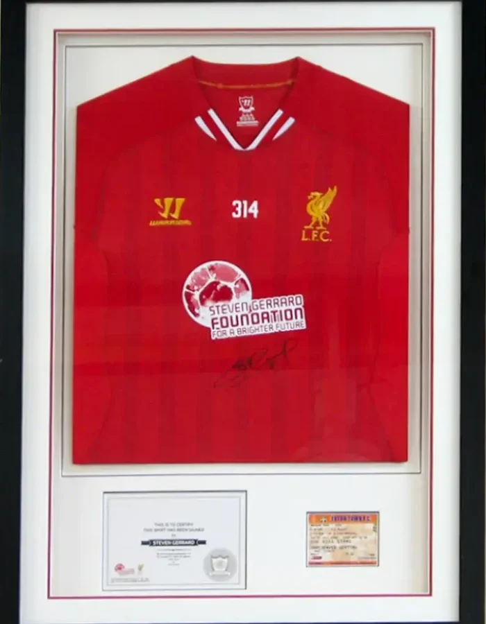 Custom framing for a football fan's shirt, displayed in a super black frame with double mounts 