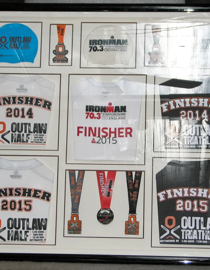 A framing showcasing sporting goods from an event, medals and memorabilia in a double mount by Nuneaton Picture Framing Company  
